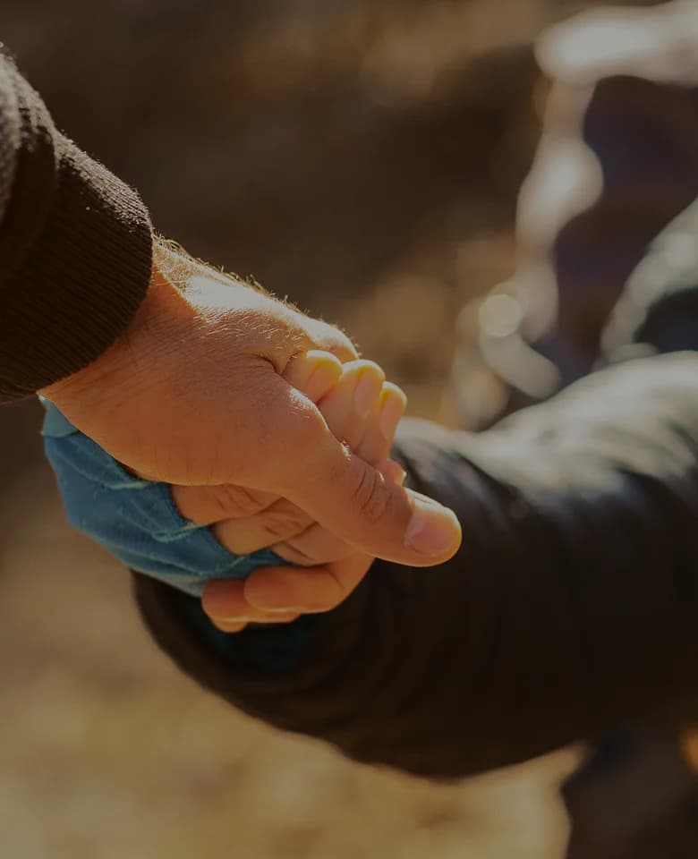 Two people holding hands