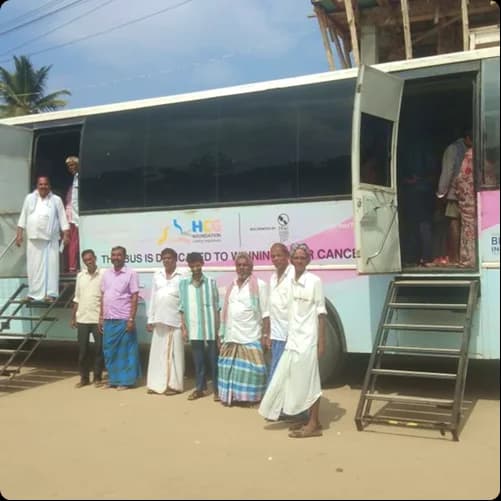 Team members beside the mobile screening bus