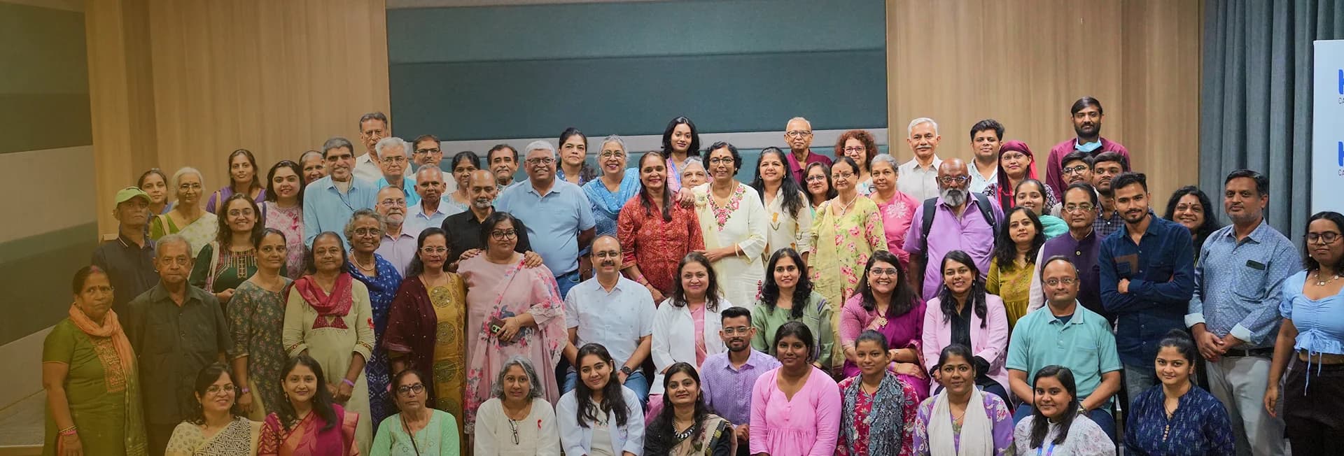 Doctors, nurses and families smiling together outside the hospital