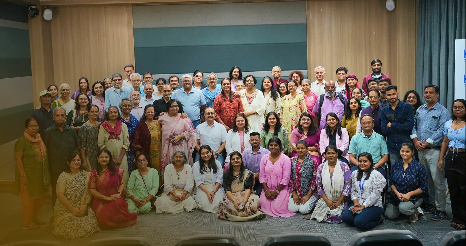 Doctors, nurses and families smiling together outside the hospital